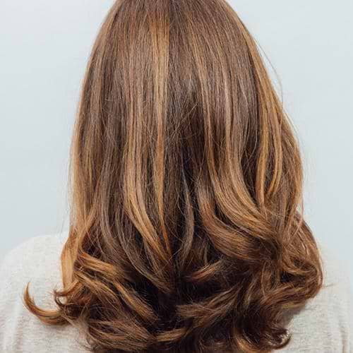 Warm honey tones on dark blonde hair after Miele Gloss application