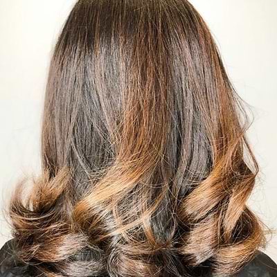 woman with brown hair with blonde highlights