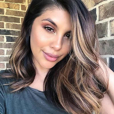 woman with brown hair with blonde highlights