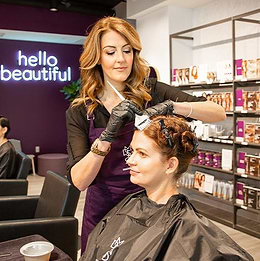 hair color applied to woman in Madison Reed Hair Color Bar