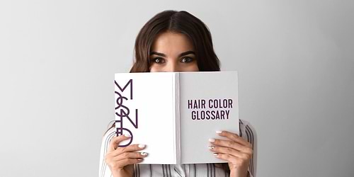 Woman holding Madison Reed Book - Hair Color Glossary