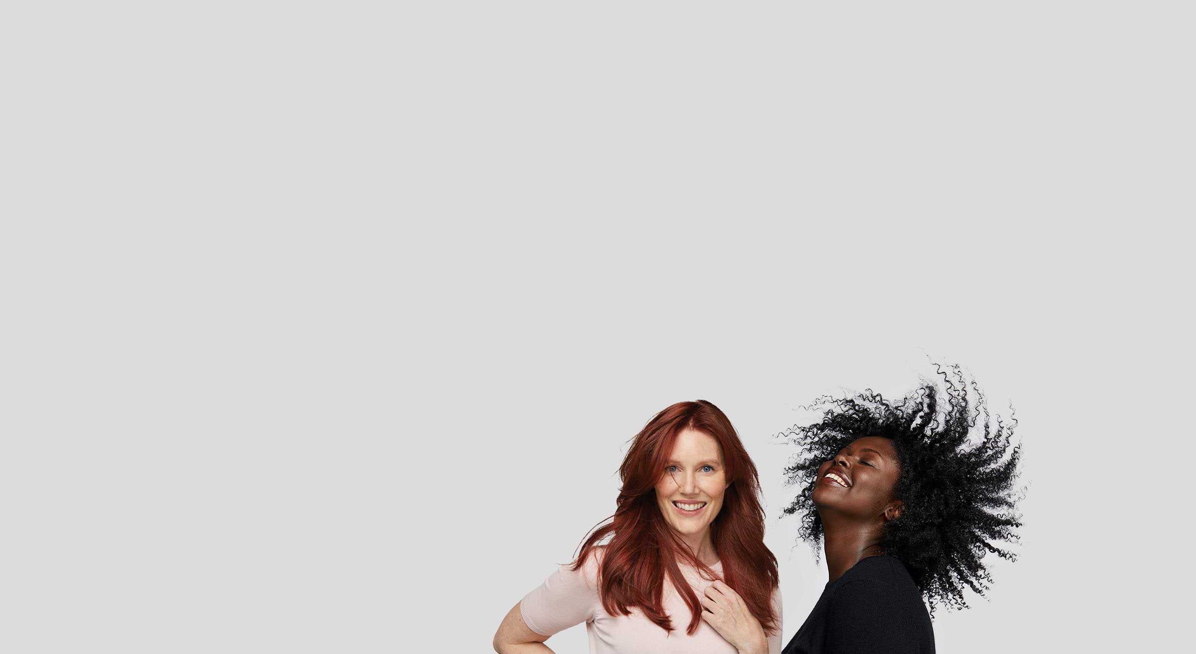 Women smiling and modeling Madison Reed hair color in red and black shades