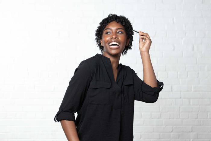 Woman smiling pulling hair strand