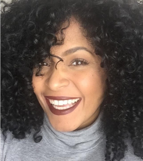 curly haired woman smiling
