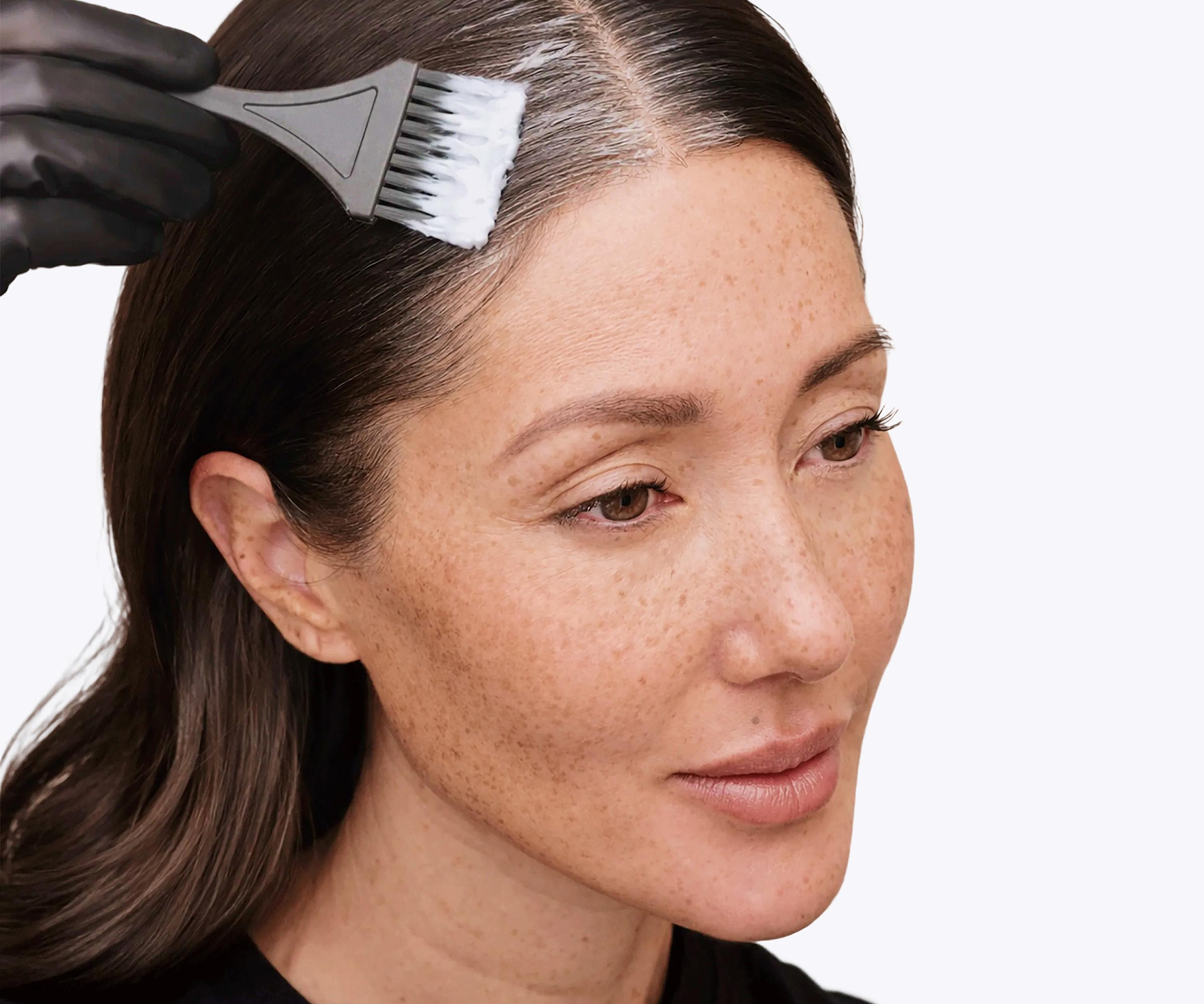 brown hair applying root perfection root touch up hair color to cover most visible roots and grays