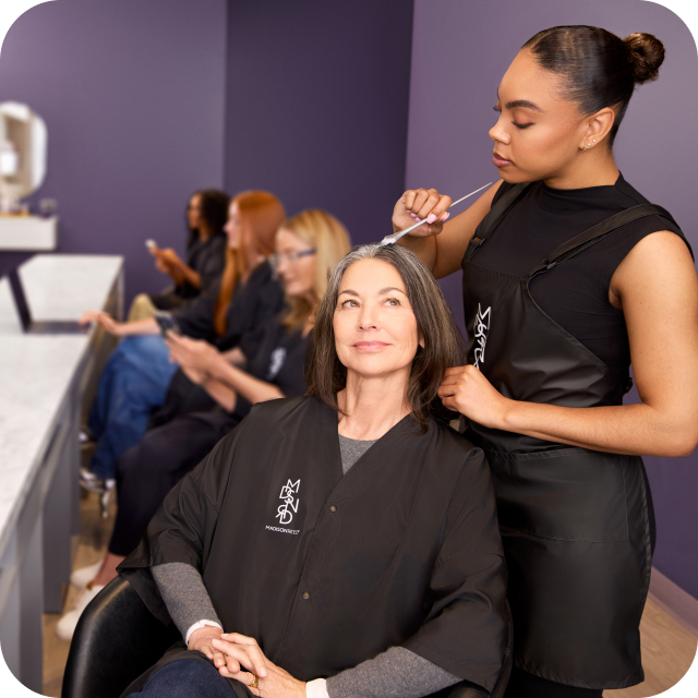Colorist applying hair color